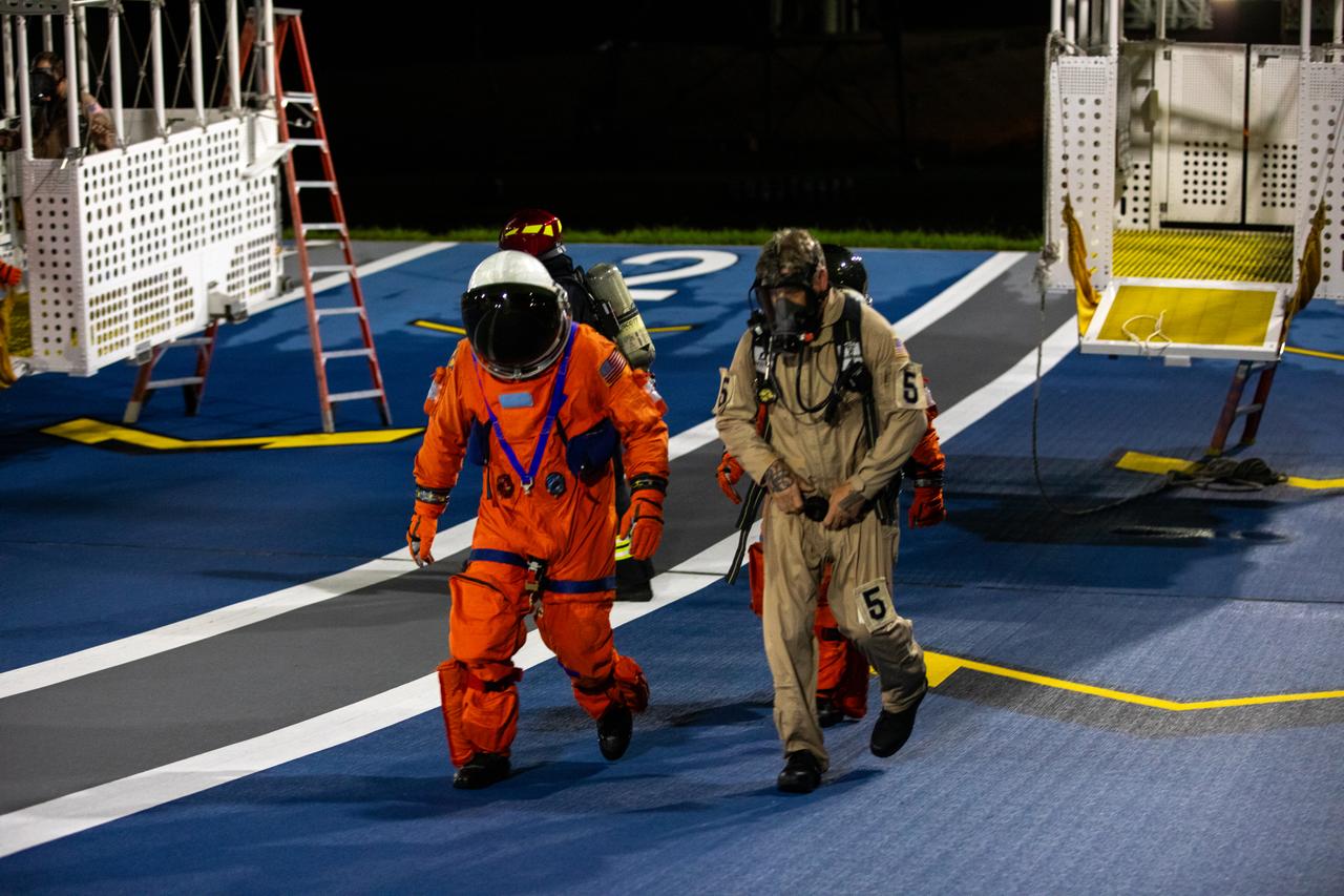 Teams at NASA’s Kennedy Space Center in Florida practice the Artemis mission emergency escape or egress procedures during a series of integrated system verification and validation tests at Launch Pad 39B on Tuesday, Aug. 13, 2024. Members of the closeout crew, pad rescue team and the Exploration Ground Systems Program practiced the process of getting inside and out of the emergency egress baskets. While the crew and other personnel will ride the emergency egress baskets to the terminus area in a real emergency, no one rode the baskets for this test. Instead, teams tested the baskets during separate occasions by using water tanks filled to different levels to replicate simulate the weight of passengers.