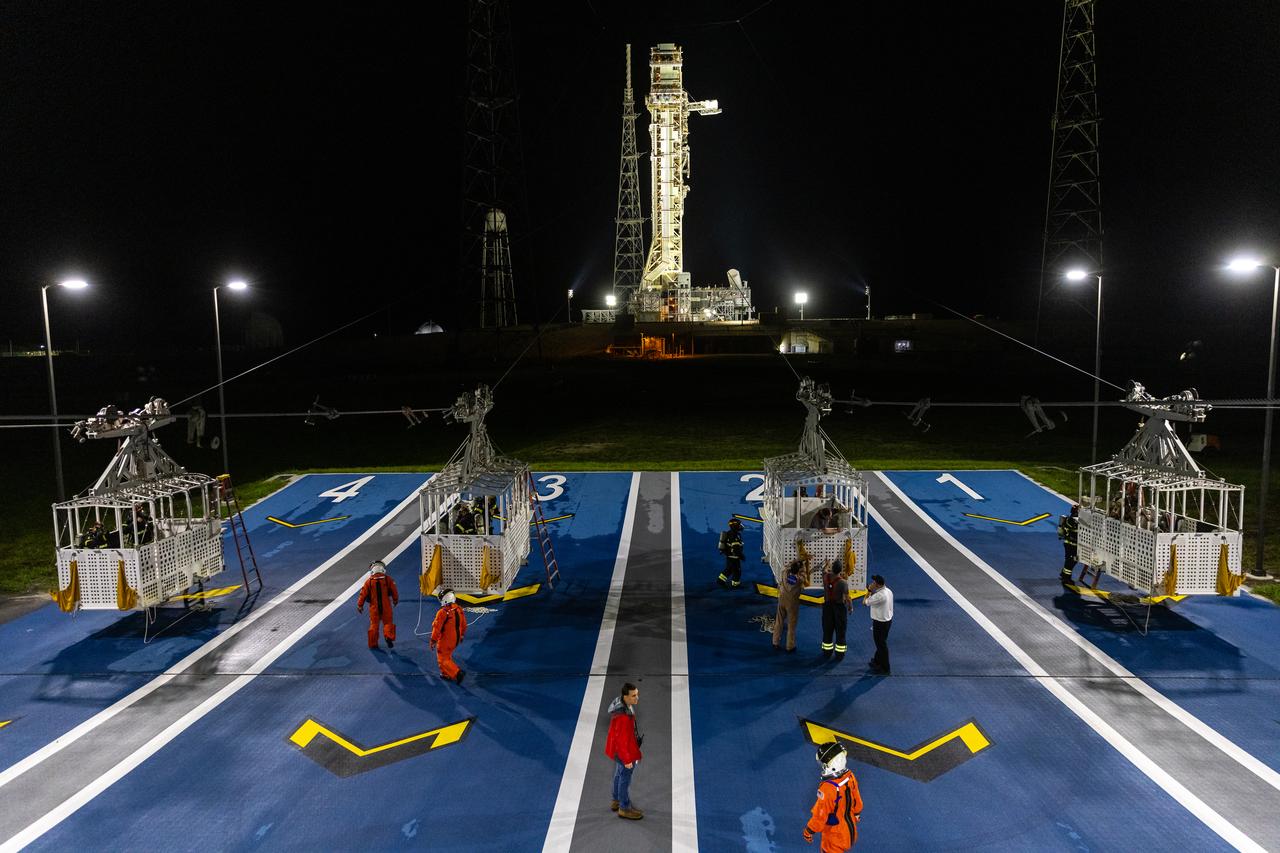 Teams at NASA’s Kennedy Space Center in Florida practice the Artemis mission emergency escape or egress procedures during a series of integrated system verification and validation tests at Launch Pad 39B on Tuesday, Aug. 13, 2024. Members of the closeout crew, pad rescue team and the Exploration Ground Systems Program practiced the process of getting inside and out of the emergency egress baskets. While the crew and other personnel will ride the emergency egress baskets to the terminus area in a real emergency, no one rode the baskets for this test. Instead, teams tested the baskets during separate occasions by using water tanks filled to different levels to replicate simulate the weight of passengers.