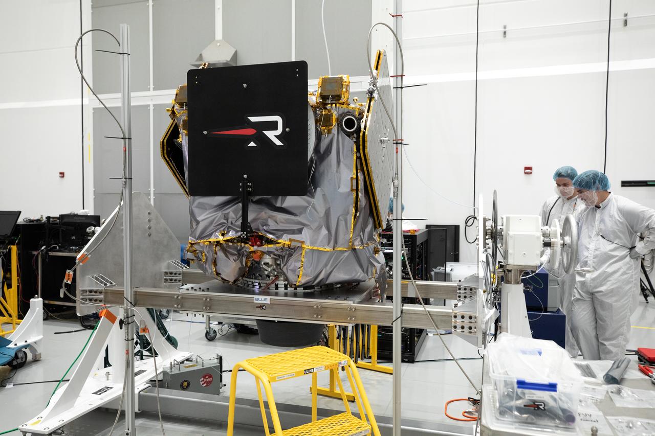 NASA’s ESCAPADE (Escape and Plasma Acceleration and Dynamics Explorers) identical dual spacecraft are inspected and processed on dollies in a high bay of the Astrotech Space Operations Facility near the agency’s Kennedy Space Center in Florida on Thursday, Aug. 22, 2024. As the first multi-spacecraft orbital science mission to Mars, ESCAPADE’s twin orbiters will take simultaneous observations from different locations around the planet and reveal the real-time response to space weather and how the Martian magnetosphere changes over time.