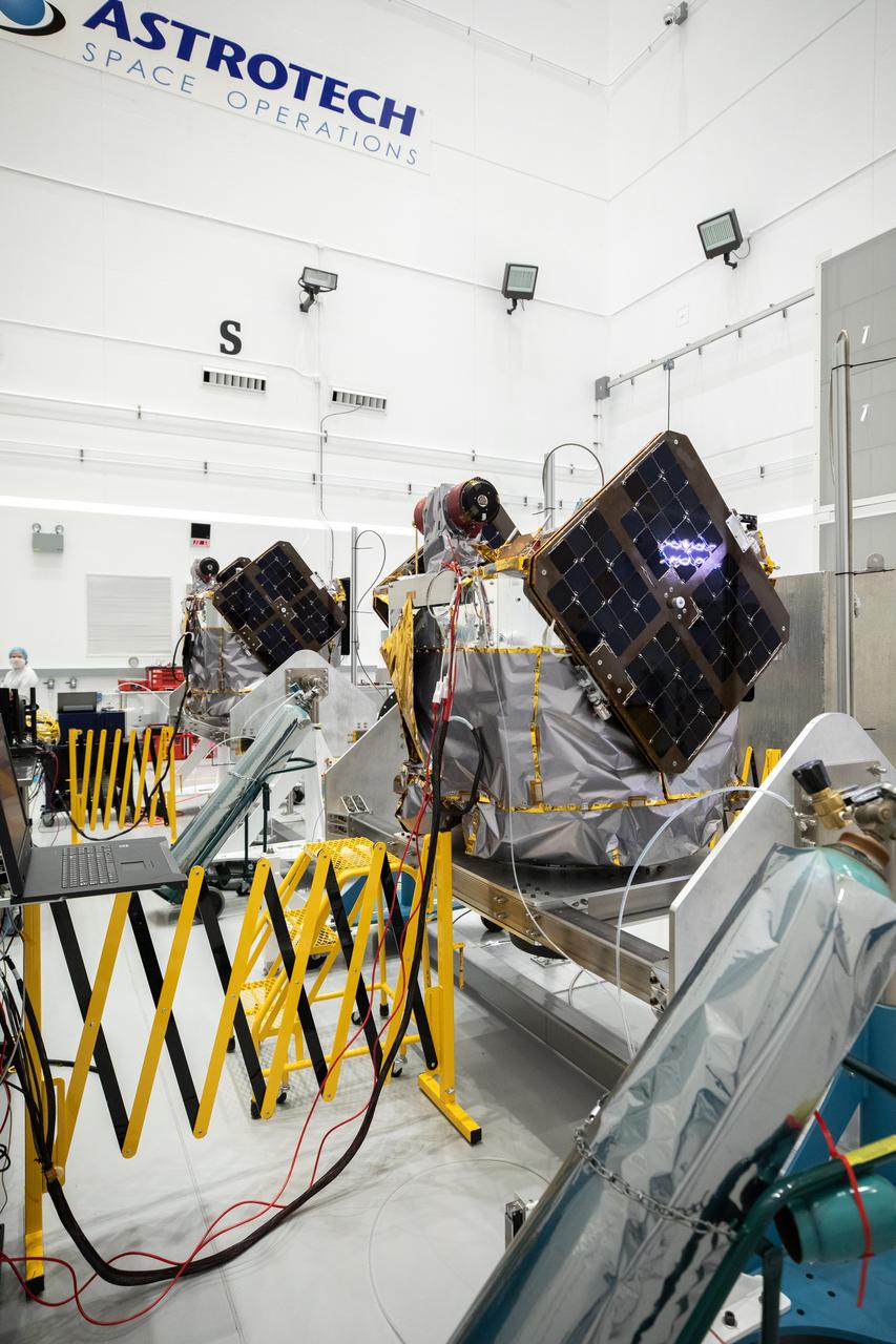 NASA’s ESCAPADE (Escape and Plasma Acceleration and Dynamics Explorers) identical dual spacecraft are inspected and processed on dollies in a high bay of the Astrotech Space Operations Facility near the agency’s Kennedy Space Center in Florida on Thursday, Aug. 22, 2024. As the first multi-spacecraft orbital science mission to Mars, ESCAPADE’s twin orbiters will take simultaneous observations from different locations around the planet and reveal the real-time response to space weather and how the Martian magnetosphere changes over time.