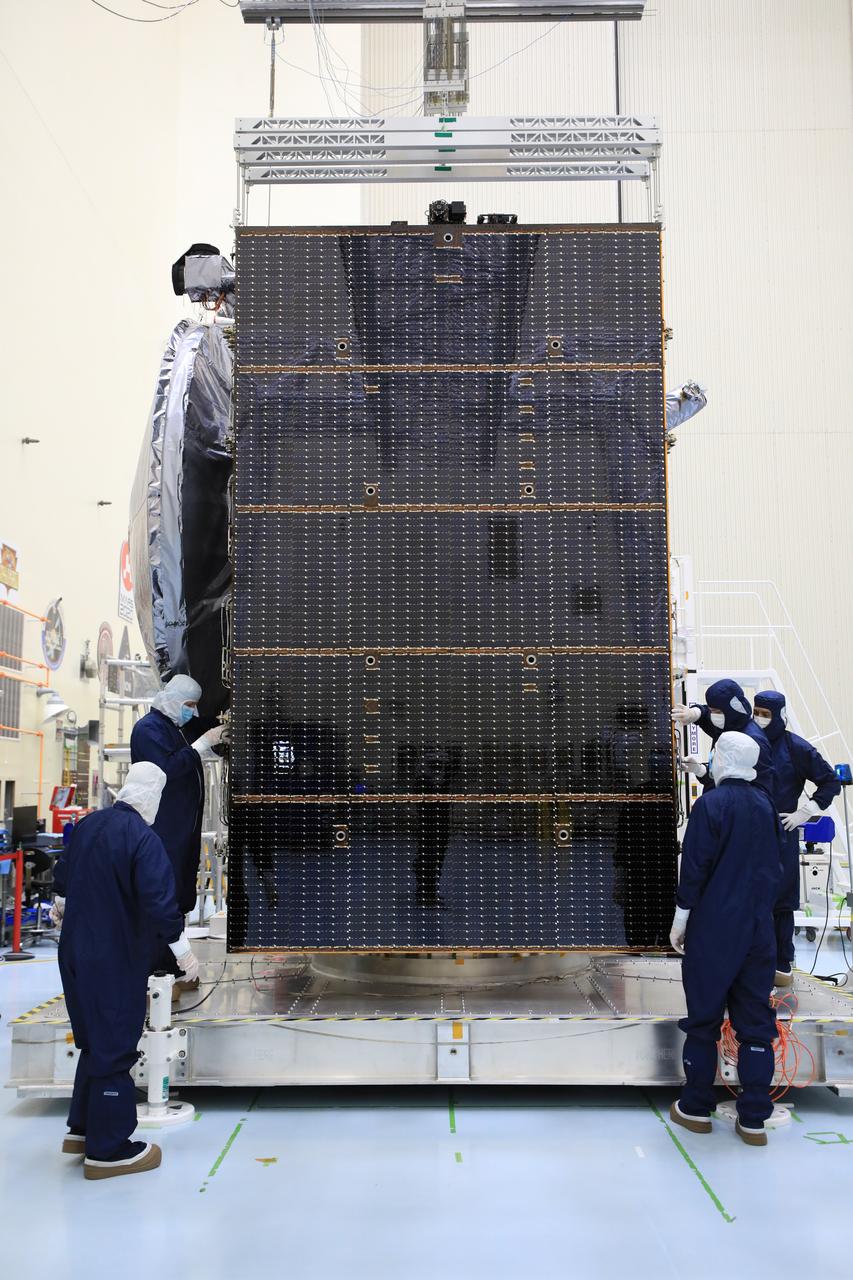 Technicians test, retract, and stow one of the two “wings” comprising the solar arrays for NASA’s Europa Clipper spacecraft on Friday, Aug. 23, 2024, at the Payload Hazardous Servicing Facility at the agency’s Kennedy Space Center in Florida. Each array measures about 46.5 feet (14.2 meters) long and about 13.5 feet (4.1 meters) high when extended. The spacecraft needs the massive solar arrays to power to Jupiter’s icy moon Europa to help scientists better understand the astrobiological potential for habitable worlds beyond our planet.