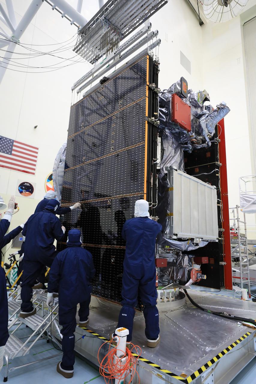 Technicians test, retract, and stow one of the two “wings” comprising the solar arrays for NASA’s Europa Clipper spacecraft on Friday, Aug. 23, 2024, at the Payload Hazardous Servicing Facility at the agency’s Kennedy Space Center in Florida. Each array measures about 46.5 feet (14.2 meters) long and about 13.5 feet (4.1 meters) high when extended. The spacecraft needs the massive solar arrays to power to Jupiter’s icy moon Europa to help scientists better understand the astrobiological potential for habitable worlds beyond our planet.