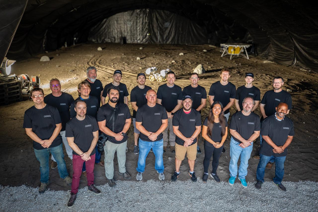 A team from the Granular Mechanics and Regolith Operations lab who developed and tested NASA’s ISRU Pilot Excavator (IPEx) pose for a photo on Friday, Aug. 30, 2024, in a testbed located at NASA’s Kennedy Space Center in Florida. IPEx functions as both an excavator and a dump truck to mine and transport lunar regolith, the loose rocky material on the Moon’s surface, which is crucial for future lunar missions and In-Situ Resource Utilization (ISRU) processes. This dual capability makes IPEx an indispensable tool for sustainable lunar exploration.