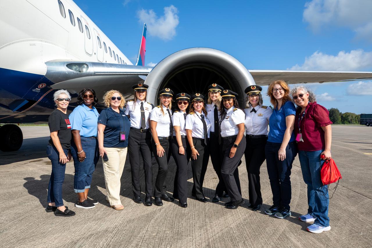 Women with leadership positions at NASA’s Kennedy Space Center pose with members of the all-female crew for Delta Air Lines’ Women Inspiring Our Next Generation (WING) flight after the crew touched down on Friday, Sept. 20, 2024, at the Launch and Landing Facility at the Florida spaceport. The flight brought girls from Atlanta, Georgia, ranging in age from 11 to 18, to view center facilities and hear a panel of women discuss their careers with NASA and Delta Air Lines.