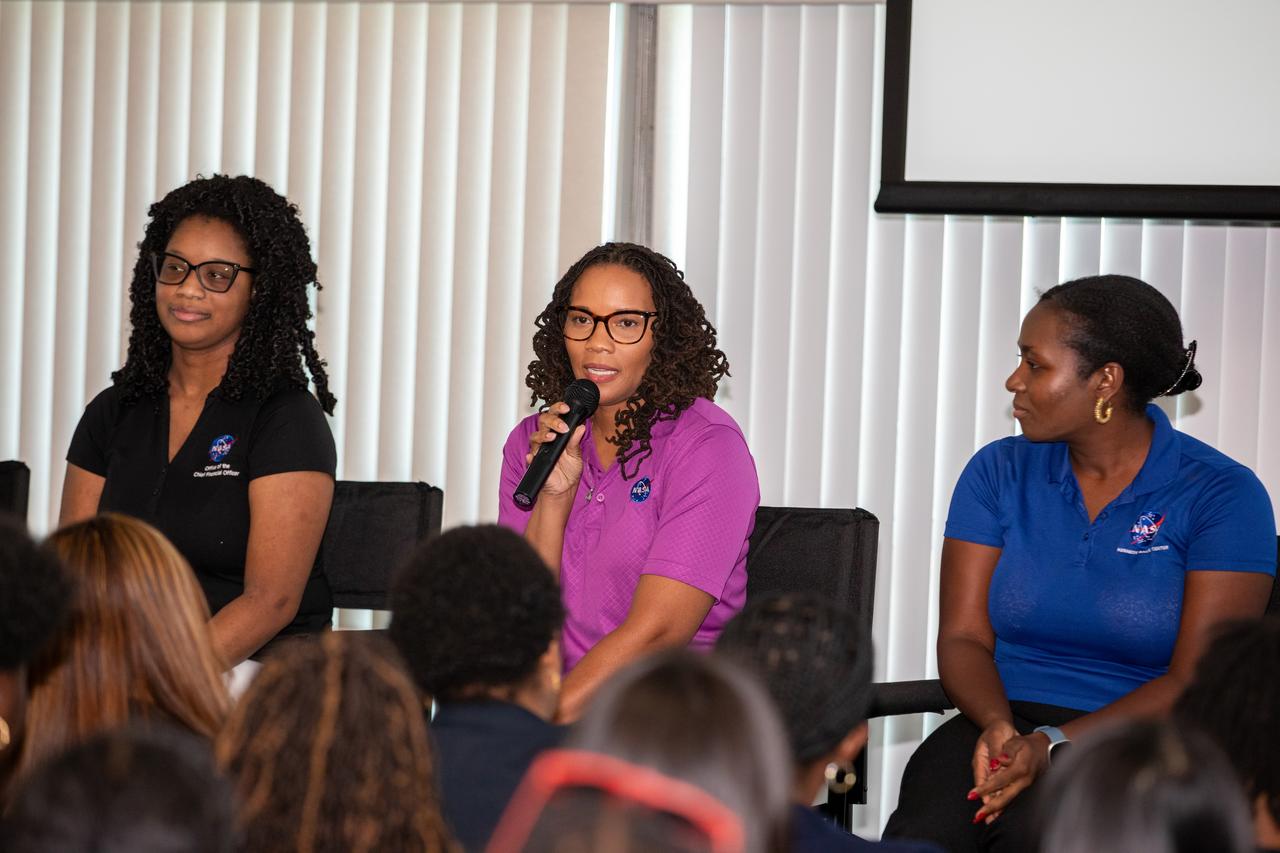 From left to right, Savitri Thomas, management and program analyst; Ales-Cia Winsley, lead Space Launch System avionics engineer; Alexandra Philip, metrology engineer, at NASA’s Kennedy Space Center in Florida, speak on Friday, Sept. 20, 2024, to young women, ages 11 to 18, from the Atlanta, Georgia area, with interests in STEM (science, technology, engineering, and math). NASA Kennedy hosted the Delta Air Lines’ Women Inspiring Our Next Generation (WING) flight to showcase various women-led STEM careers available at the Florida spaceport.