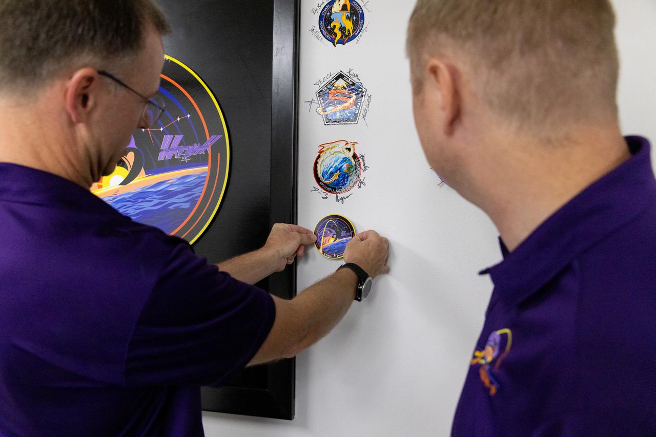 NASA astronaut Nick Hague applies NASA’s SpaceX Crew-9 mission patch to the wall inside the Astronaut Crew Quarters in the Neil A. Armstrong Operations and Checkout Building at the agency’s Kennedy Space Center in Florida on Monday, Sept. 23, 2024. Crew-9 is the ninth crew rotation mission of the SpaceX Dragon spacecraft and Falcon 9 rocket that will send Hague and Roscosmos cosmonaut Aleksandr Gorbunov to the International Space Station as part of the agency’s Commercial Crew Program. The mission is scheduled to launch at 2:05 p.m. EDT Sept. 26, 2024, from Space Launch Complex-40 at Cape Canaveral Space Force Station in Florida.