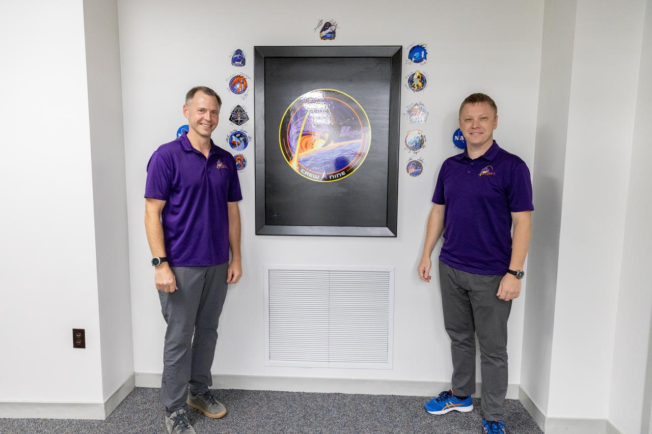 NASA astronaut Nick Hague (left) and Roscosmos cosmonaut Aleksandr Gorbunov pose inside the Astronaut Crew Quarters in the Neil A. Armstrong Operations and Checkout Building at NASA’s Kennedy Space Center in Florida on Monday, Sept. 23, 2024. Hague and Gorbunov will launch on NASA’s SpaceX Crew-9 mission – the ninth crew rotation mission of the SpaceX Dragon spacecraft and Falcon 9 rocket that will send the crew to the International Space Station as part of the agency’s Commercial Crew Program. The mission is scheduled to launch at 2:05 p.m. EDT Sept. 26, 2024, from Space Launch Complex-40 at Cape Canaveral Space Force Station in Florida.