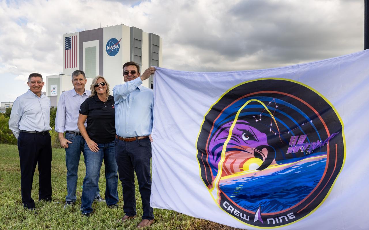 From left, Richard Jones, CCP (Commercial Crew Program) deputy program manager at NASA’s Johnson Space Center in Houston; Steve Stich, program manager for CCP; Dana Hutcherson, CCP deputy program manager at NASA’s Kennedy Space Center in Florida; and David Forrest, deputy manager, SE&I (Systems Engineering and Integration) Office, NASA’s Commercial Low Earth Orbit Development Program, pose with the agency’s SpaceX Crew-9 mission flag near the countdown clock at the NASA News Center at Kennedy on Tuesday, Sept. 24, 2024. Forrest previously served as deputy manager for CCP’s SE&I Office at Kennedy. The Crew-9 mission will send NASA astronaut Nick Hague and Roscosmos cosmonaut Aleksandr Gorbunov to the International Space Station aboard SpaceX’s Dragon spacecraft and Falcon 9 rocket. 