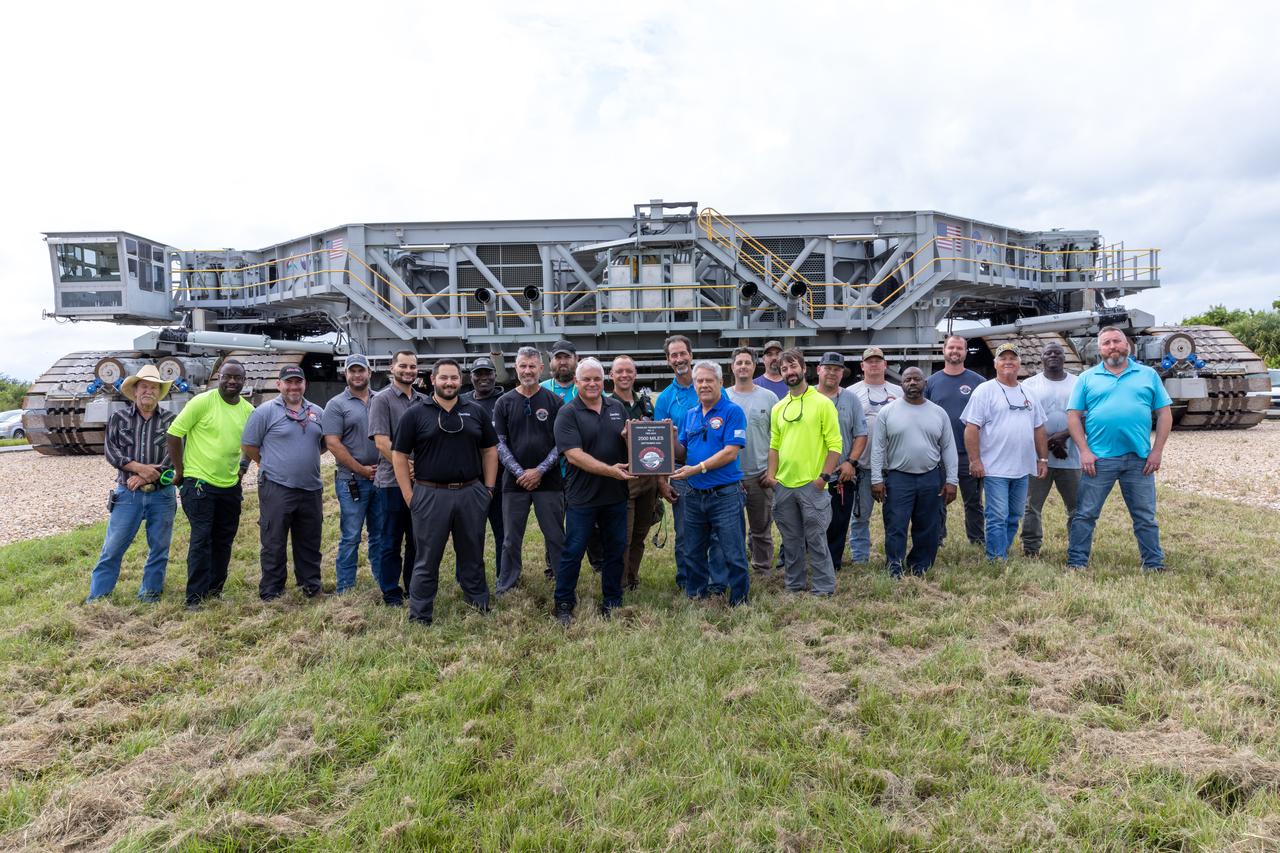 Teams with NASA’s Exploration Ground Systems at NASA’s Kennedy Space Center in Florida celebrate on Wednesday, Sept. 25, 2024, the agency’s crawler-transporter 2 reaching the milestone of 2,500 miles traveled since its construction in 1965. Crawler-transporter 2 reached the milestone while teams took it on a trip in preparation for supporting the roll of the mobile launcher from Launch Pad 39B back into the spaceport’s Vehicle Assembly Building ahead of the Artemis II launch. Built originally to transport massive Saturn V rockets during the Apollo Program, crawler-transporter 2 continued its service during the Space Shuttle Program, and currently transports the massive SLS (Space Launch System) rocket and Orion spacecraft atop the mobile launcher as part of the agency’s Artemis campaign. 