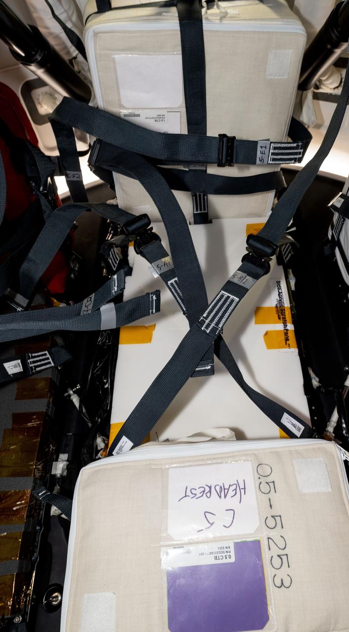 This image shows one of the temporary seat structures built and installed on the Crew-8 Dragon in cargo pallet locations C7 and C5 using foam, straps, and other station soft goods such as cushions.