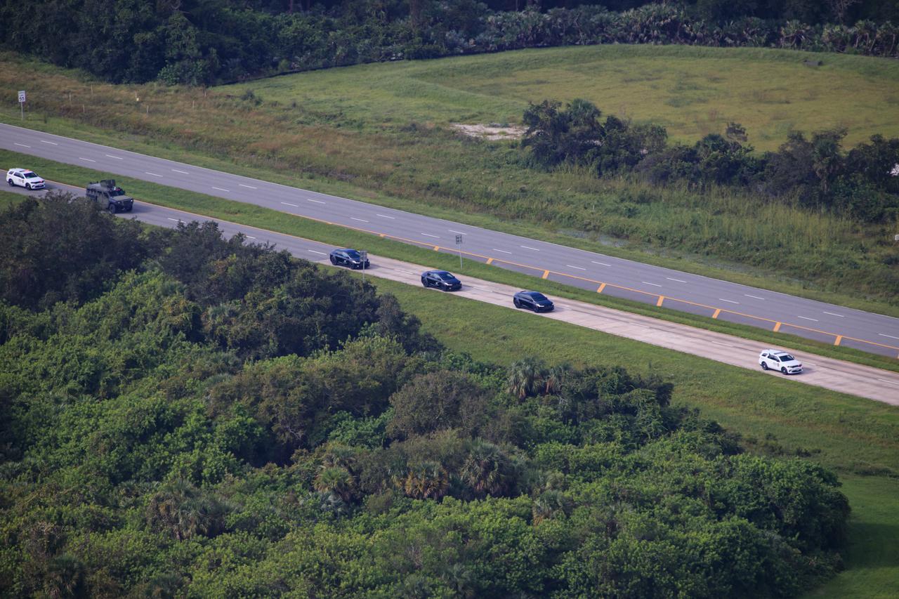 The vehicle convoy carrying NASA astronaut Nick Hague and Roscosmos cosmonaut Aleksandr Gorbunov makes the journey from the Neil A. Armstrong Operations and Checkout Building at the agency’s Kennedy Space Center in Florida to Space Launch Complex-40 at nearby Cape Canaveral Space Force Station ahead of launch on Saturday, Sept. 28, 2024. Hague and Gorbunov will launch to the International Space Station aboard SpaceX’s Dragon spacecraft and Falcon 9 rocket. Launch is targeted for 1:17 p.m. EDT for the ninth crew rotation mission with SpaceX to the space station as part of the agency’s Commercial Crew Program. 