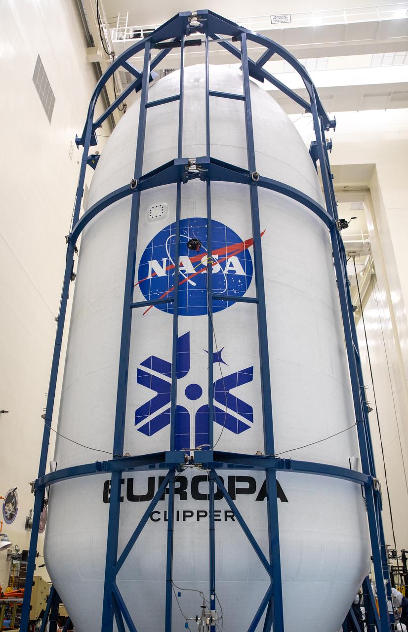 Technicians encapsulated NASA’s Europa Clipper spacecraft inside payload fairings on Wednesday, Oct. 2, 2024, in the Payload Hazardous Servicing Facility at NASA’s Kennedy Space Center in Florida. The fairings will protect the spacecraft during launch as it begins its journey to explore Jupiter’s icy moon, Europa. The mission will help scientists determine if the moon could support life. NASA and SpaceX are targeting launch at 12:31 p.m. EDT on Thursday, Oct. 10, 2024, from Launch Complex 39A at Kennedy Space Center in Florida.