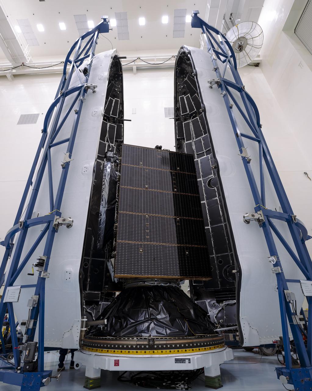 Technicians prepare to encapsulate NASA’s Europa Clipper spacecraft inside SpaceX’s Falcon Heavy payload fairing in the Payload Hazardous Servicing Facility at NASA’s Kennedy Space Center in Florida on Wednesday, Oct. 2, 2024. The payload fairing will protect the spacecraft during liftoff from Launch Complex 39A on its journey to explore Jupiter’s icy moon, Europa. The spacecraft will complete nearly 50 flybys of Jupiter’s icy moon, Europa, to determine if there are conditions suitable for life beyond Earth.