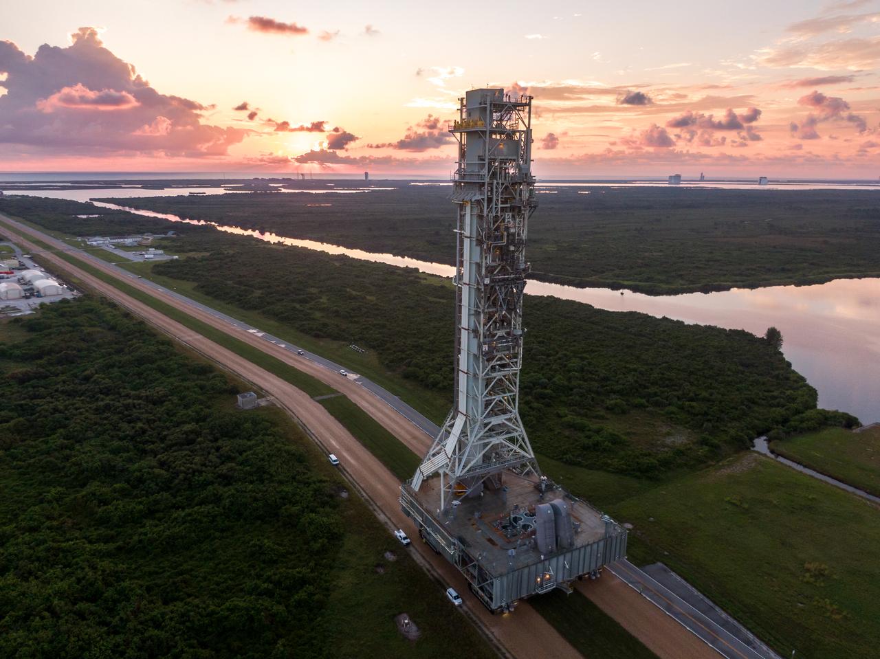 A drone camera captures NASA’s mobile launcher 1 atop the agency’s crawler-transporter 2 moving from Launch Complex 39B to the Vehicle Assembly Building at NASA’s Kennedy Space Center in Florida on Thursday, Oct. 3, 2024. The mobile launcher has been at the launch pad since August 2023 undergoing upgrades and tests in preparation for NASA’s Artemis II mission. The mobile launcher will be used to assemble, process, and launch NASA’s SLS (Space Launch Systems) and Orion spacecraft to the Moon and beyond. 