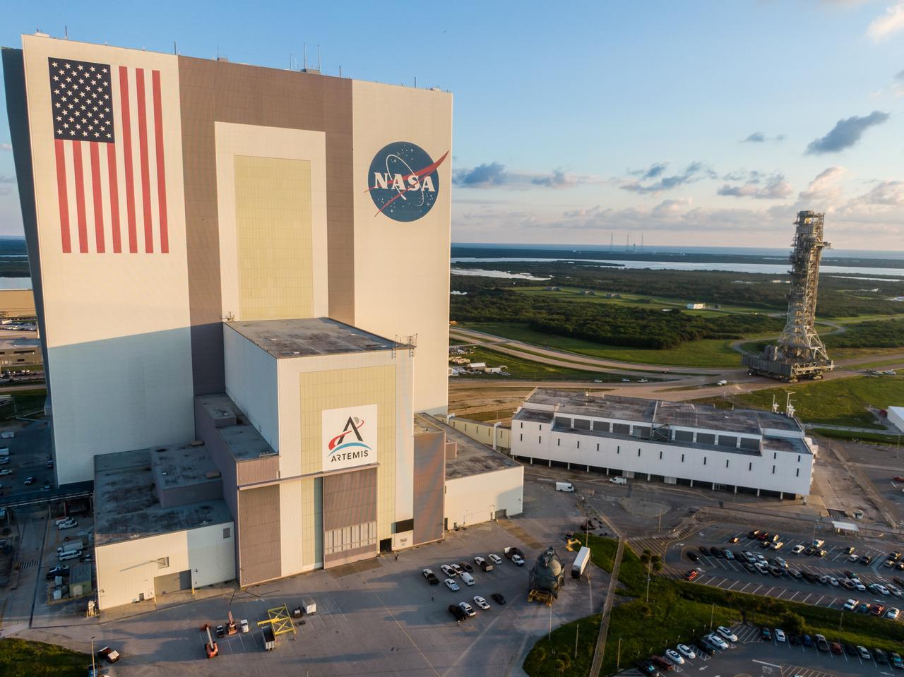 A drone camera captures NASA’s mobile launcher 1 atop the agency’s crawler-transporter 2 moving from Launch Complex 39B approaching to enter the Vehicle Assembly Building at NASA’s Kennedy Space Center in Florida on Thursday, Oct. 3, 2024. The mobile launcher has been at the launch pad since August 2023 undergoing upgrades and tests in preparation for NASA’s Artemis II mission. The mobile launcher will be used to assemble, process, and launch NASA’s SLS (Space Launch Systems) and Orion spacecraft to the Moon and beyond. 