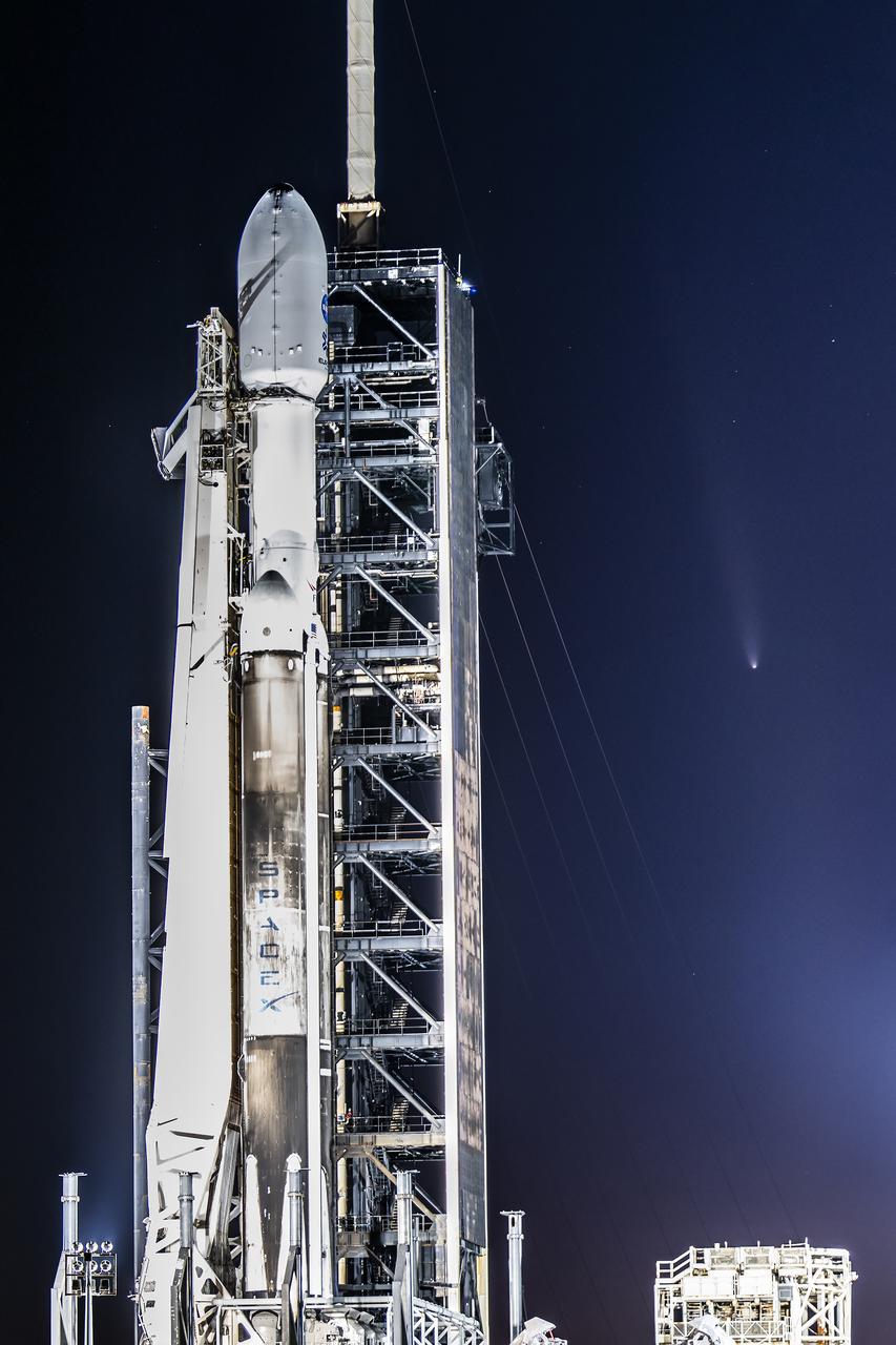 Comet C/2023 A3 (Tsuchinshan-Atlas) illuminates the sky behind NASA’s Europa Clipper spacecraft on the SpaceX Falcon Heavy rocket at Launch Complex 39A on Sunday, Oct. 13, 2024, at the agency’s Kennedy Space Center in Florida ahead of launch to Jupiter’s icy moon, Europa. The spacecraft will complete nearly 50 flybys of Europa to determine if there are conditions suitable for life beyond Earth. 
