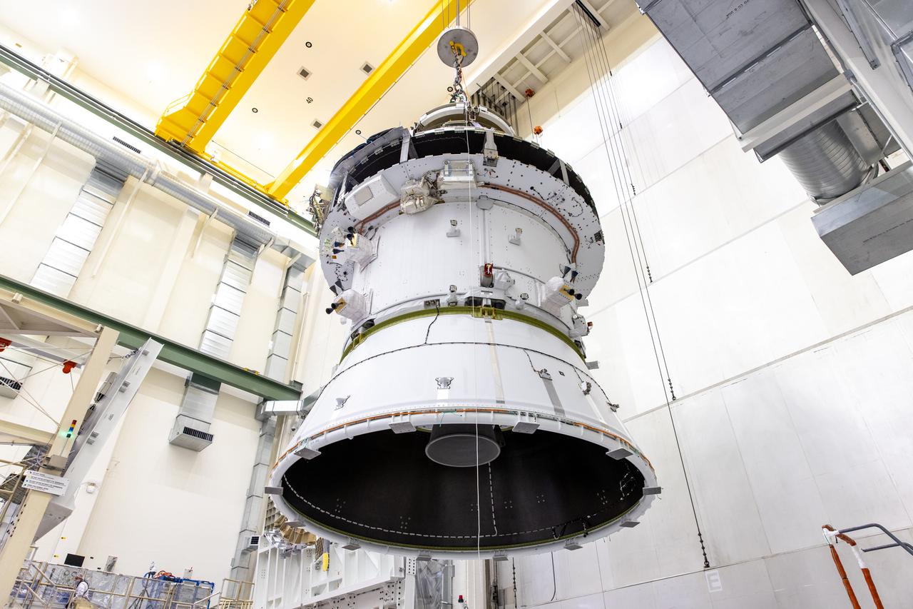 A massive crane lifts NASA’s Orion spacecraft out of the Final Assembly and System Testing cell and moves it to the altitude chamber to complete further testing on Thursday, Nov. 7, 2024, inside the Neil A. Armstrong Operations and Checkout building at NASA's Kennedy Space Center in Florida. The altitude chamber simulates deep space vacuum conditions, and the testing will provide additional data to augment data gained during testing earlier this summer. The Orion spacecraft will carry NASA astronauts Victor Glover, Christina Koch, and Reid Wiseman, as well as CSA (Canadian Space Agency) astronaut Jeremy Hansen, on a 10-day journey around the Moon and back for the Artemis II test flight.