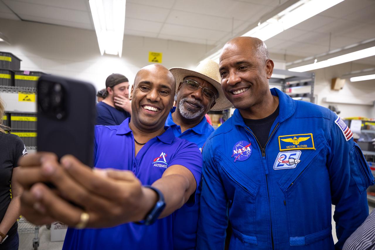 NASA astronaut Victor Glover takes photos during a visit on Friday, Nov. 8, 2024, with employees at NASA’s Kennedy Space Center in Florida. The employees support the agency’s Exploration Ground Systems Program to help NASA send astronauts, including Glover, to the Moon and back through the Artemis II launch. 