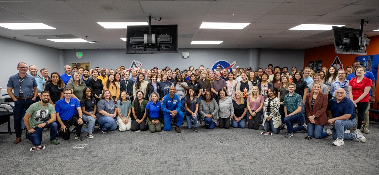 NASA astronaut Victor Glover poses for a group photo during a visit on Friday, Nov. 8, 2024, with employees from Amentum COMET (Consolidated Operations, Management, Engineering and Test) at NASA’s Kennedy Space Center in Florida. Amentum COMET works with the agency’s Exploration Ground Systems Program to help NASA send astronauts, including Glover, to the Moon and back through the Artemis II launch.
