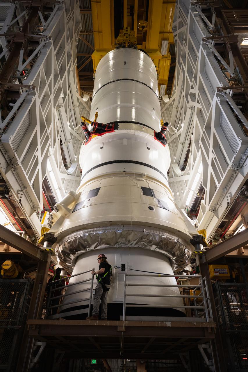 Engineers and technicians with the Exploration Ground Systems Program prepare to transfer one of the aft assemblies of the SLS (Space Launch System) solid rocket boosters for the Artemis II mission with an overhead crane inside the Rotation, Processing and Surge Facility at NASA’s Kennedy Space Center in Florida on Wednesday, Nov. 13, 2024. The booster segments are being transferred to the NASA Kennedy’s Vehicle Assembly Building via a transporter for stacking operations in preparation for launch of the Artemis II mission.