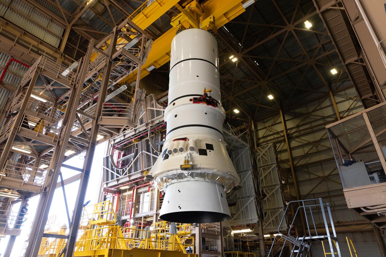 Engineers and technicians with the Exploration Ground Systems Program prepare to transfer one of the aft assemblies of the SLS (Space Launch System) solid rocket boosters for the Artemis II mission with an overhead crane inside the Rotation, Processing and Surge Facility at NASA’s Kennedy Space Center in Florida on Wednesday, Nov. 13, 2024. The booster segments are being transferred to the NASA Kennedy’s Vehicle Assembly Building via a transporter for stacking operations in preparation for launch of the Artemis II mission.