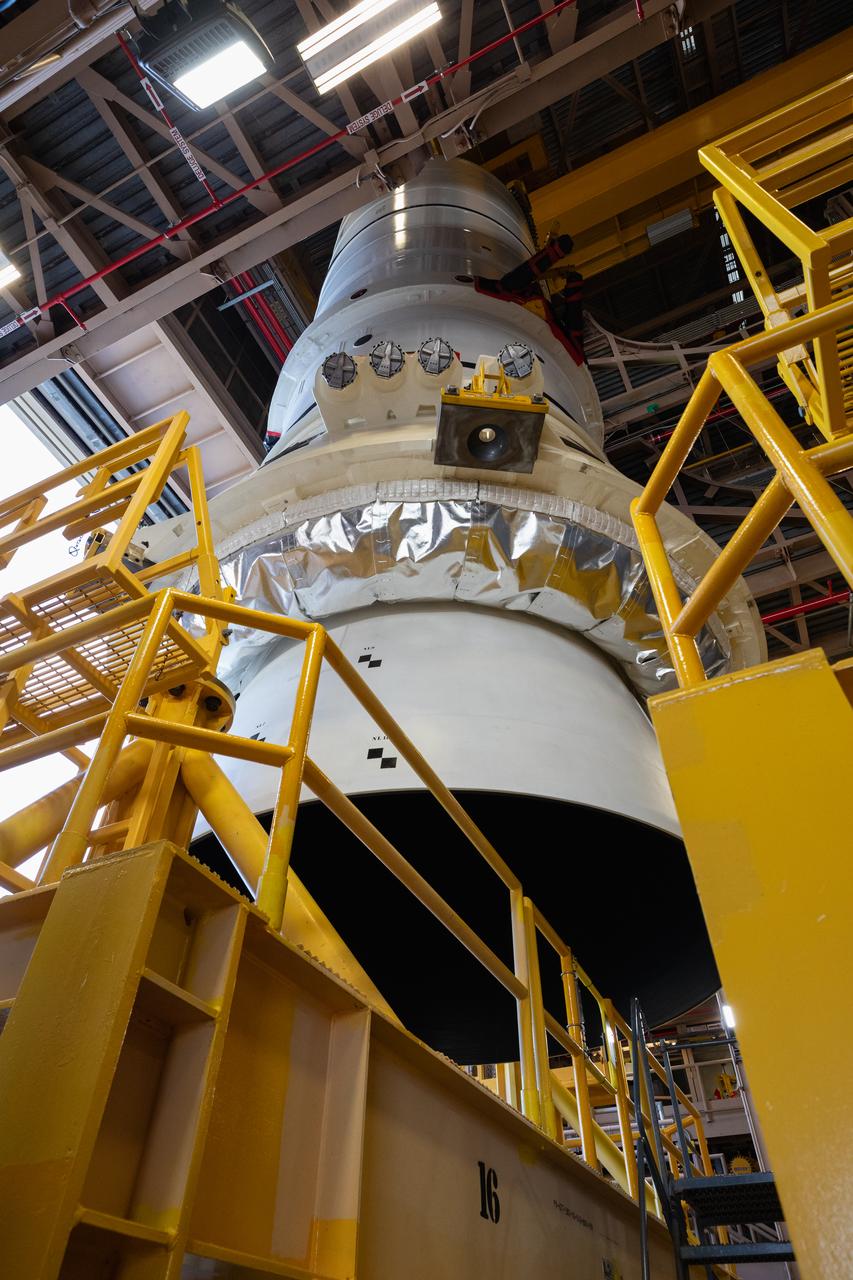 Engineers and technicians with the Exploration Ground Systems Program prepare to transfer one of the aft assemblies of the SLS (Space Launch System) solid rocket boosters for the Artemis II mission with an overhead crane inside the Rotation, Processing and Surge Facility at NASA’s Kennedy Space Center in Florida on Wednesday, Nov. 13, 2024. The booster segments are being transferred to the NASA Kennedy’s Vehicle Assembly Building via a transporter for stacking operations in preparation for launch of the Artemis II mission.