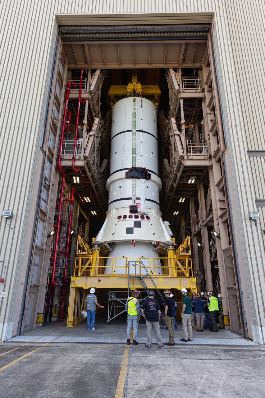 Engineers and technicians with the Exploration Ground Systems Program prepare to transfer one of the aft assemblies of the SLS (Space Launch System) solid rocket boosters for the Artemis II mission with an overhead crane inside the Rotation, Processing and Surge Facility at NASA’s Kennedy Space Center in Florida on Wednesday, Nov. 13, 2024. The booster segments are being transferred to the NASA Kennedy’s Vehicle Assembly Building via a transporter for stacking operations in preparation for launch of the Artemis II mission.