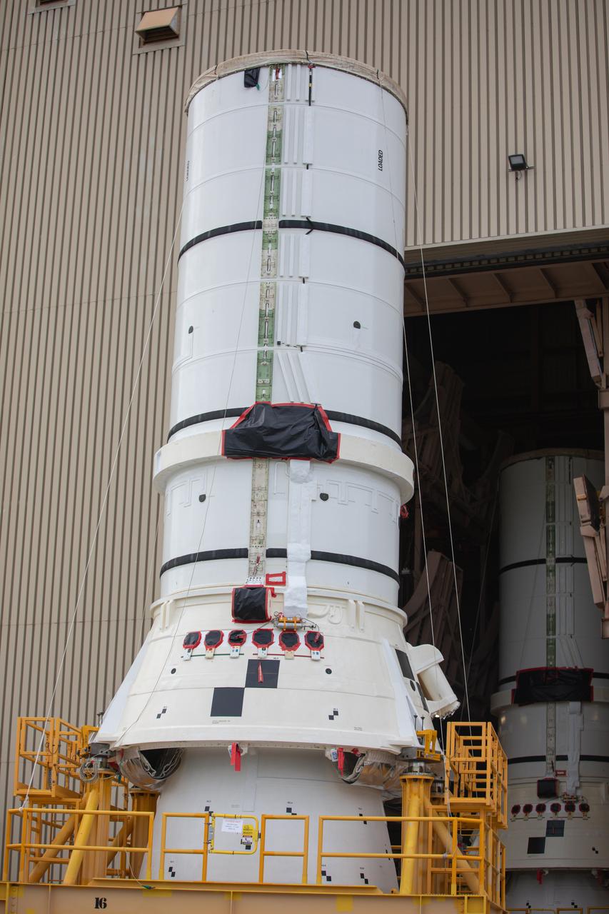 The left aft assembly of the SLS (Space Launch System) solid rocket boosters for the Artemis II mission is moved from the Rotation, Processing and Surge Facility to the Vehicle Assembly Building at NASA’s Kennedy Space Center in Florida on Monday, Nov. 18, 2024. The aft assembly will be lifted atop the mobile launcher, followed by the right aft assembly and remaining booster segments. 