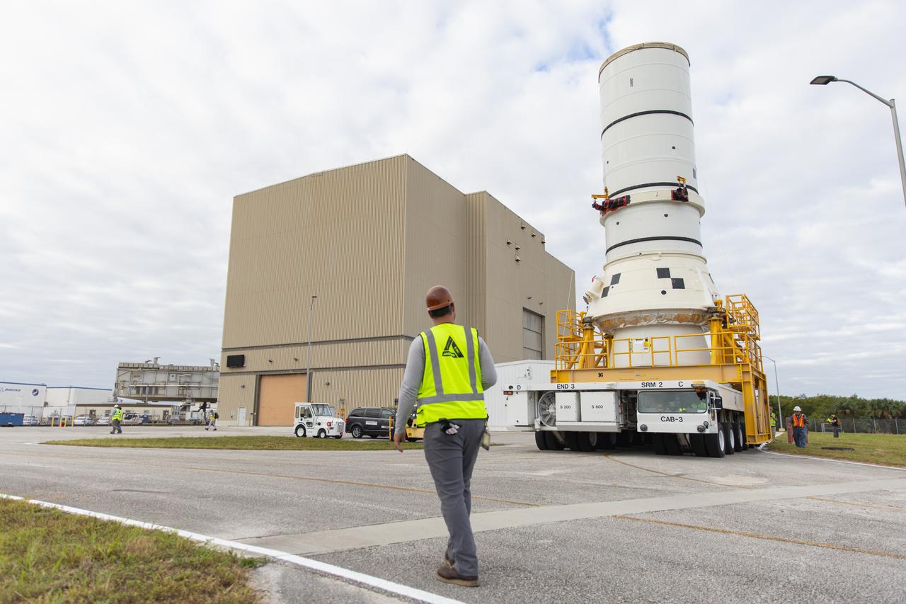 The left aft assembly of the SLS (Space Launch System) solid rocket boosters for the Artemis II mission is moved from the Rotation, Processing and Surge Facility to the Vehicle Assembly Building at NASA’s Kennedy Space Center in Florida on Monday, Nov. 18, 2024. The aft assembly will be lifted atop the mobile launcher, followed by the right aft assembly and remaining booster segments. 