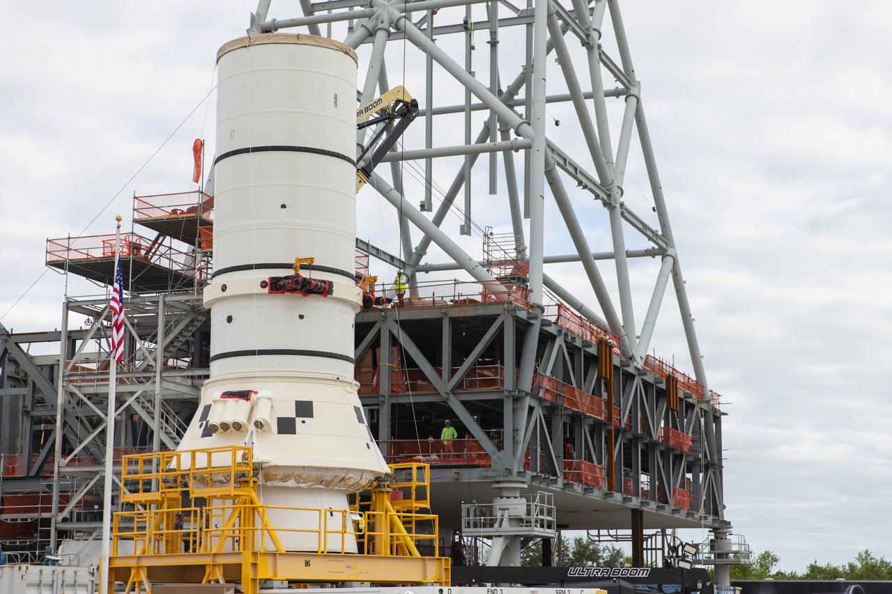 The left aft assembly of the SLS (Space Launch System) solid rocket boosters for the Artemis II mission is moved from the Rotation, Processing and Surge Facility to the Vehicle Assembly Building at NASA’s Kennedy Space Center in Florida on Monday, Nov. 18, 2024. The aft assembly will be lifted atop the mobile launcher, followed by the right aft assembly and remaining booster segments. 