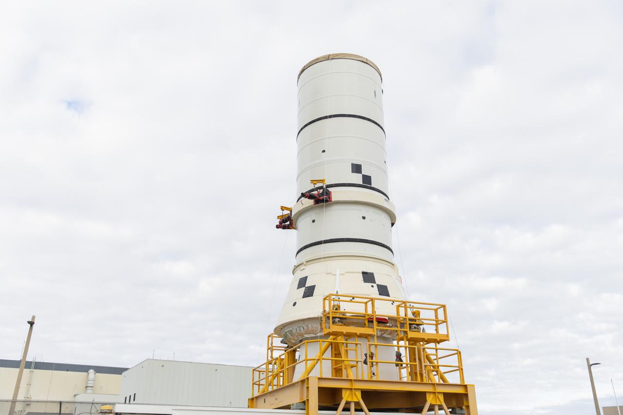 The left aft assembly of the SLS (Space Launch System) solid rocket boosters for the Artemis II mission is moved from the Rotation, Processing and Surge Facility to the Vehicle Assembly Building at NASA’s Kennedy Space Center in Florida on Monday, Nov. 18, 2024. The aft assembly will be lifted atop the mobile launcher, followed by the right aft assembly and remaining booster segments. 