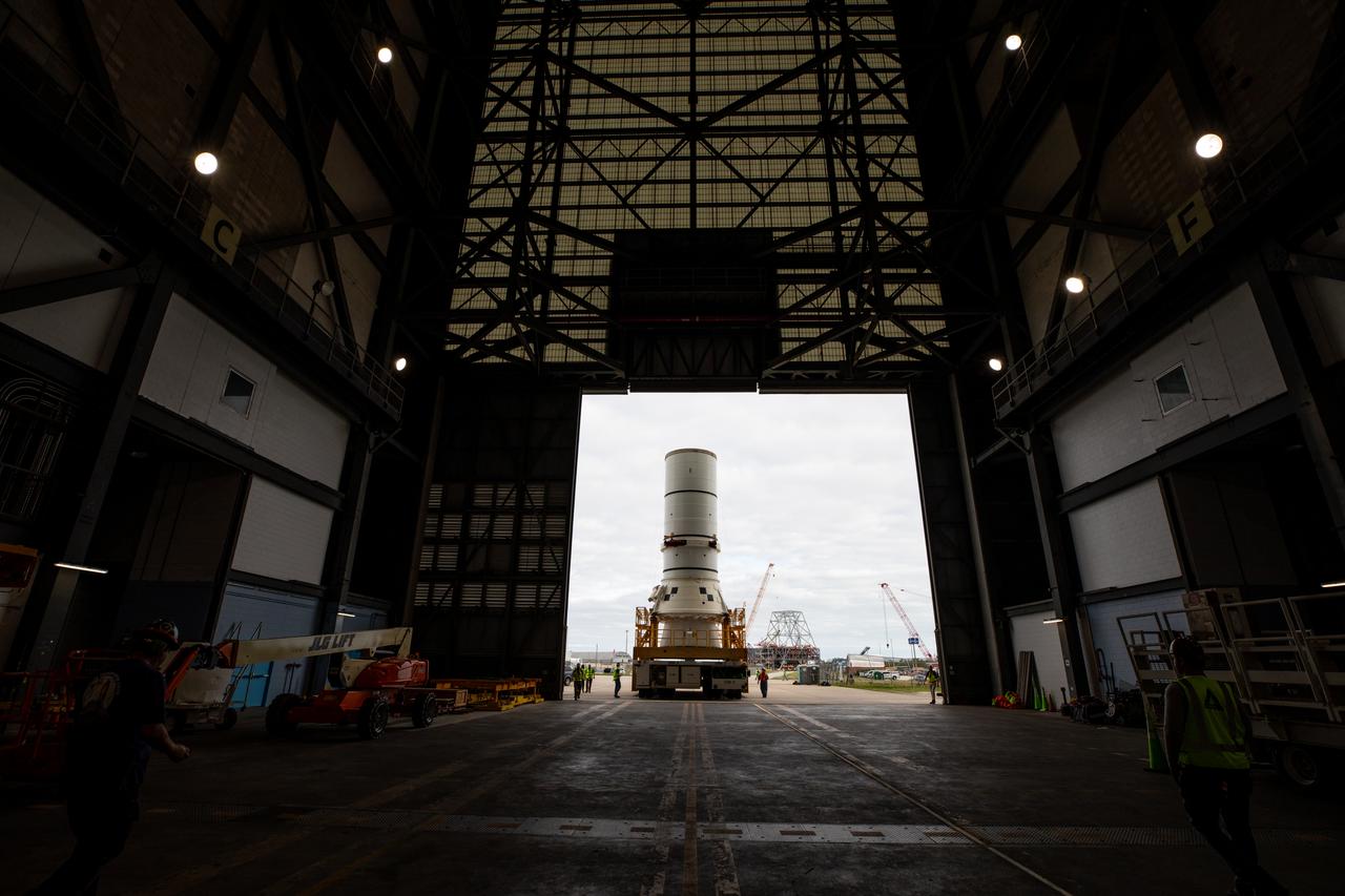 Engineers and technicians with the Exploration Ground Systems Program transport the left aft assembly, or bottom portion of the solid rocket boosters for the SLS (Space Launch System) rocket for the Artemis II mission inside the Vehicle Assembly Building at NASA’s Kennedy Space Center in Florida on Monday, Nov. 18, 2024. The aft assembly will be lifted atop the mobile launcher, followed by the right aft assembly and remaining booster segments. 