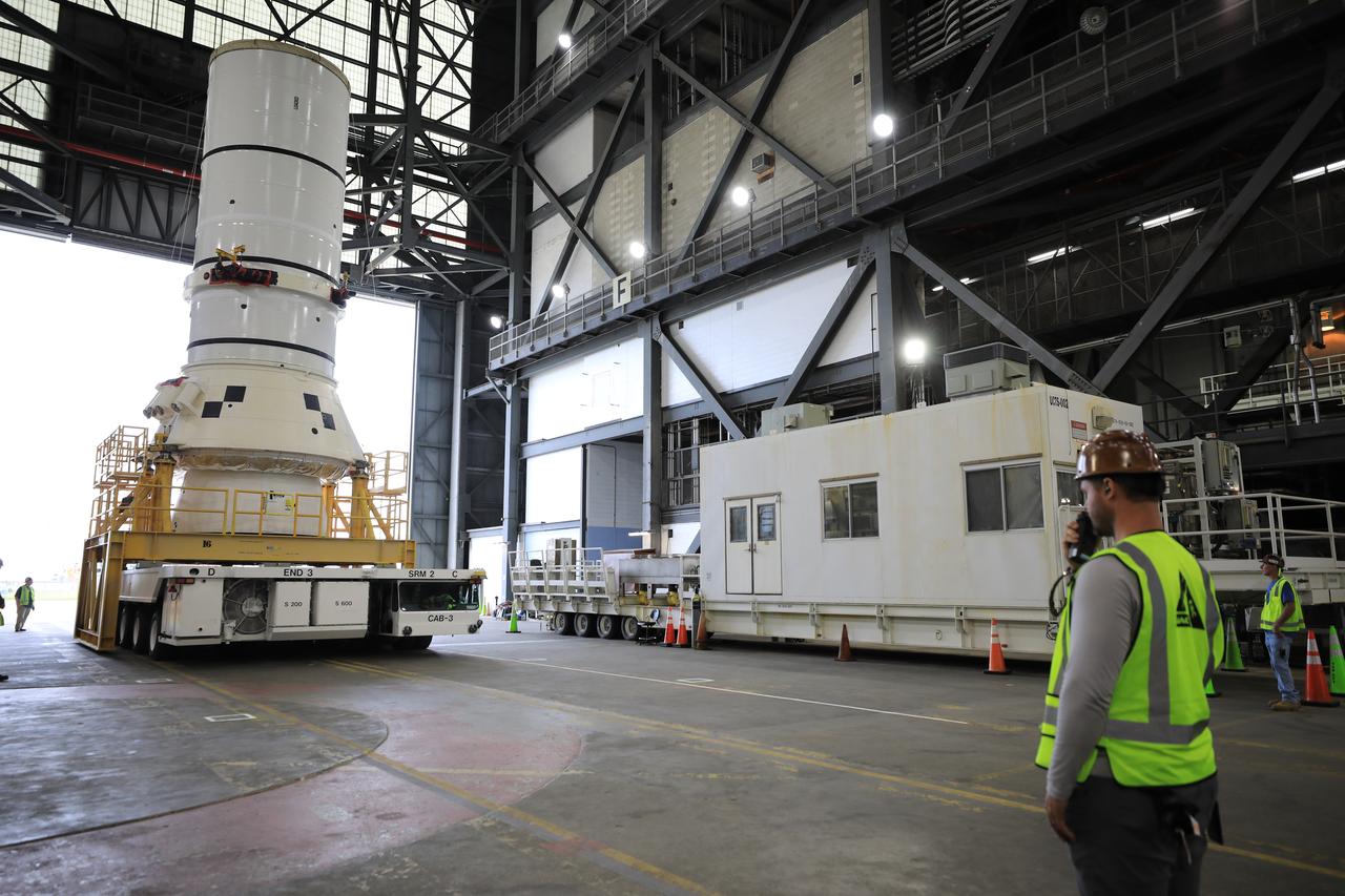 Engineers and technicians with the Exploration Ground Systems Program transport the left aft assembly, or bottom portion of the solid rocket boosters for the SLS (Space Launch System) rocket for the Artemis II mission inside the Vehicle Assembly Building at NASA’s Kennedy Space Center in Florida on Monday, Nov. 18, 2024. The aft assembly will be lifted atop the mobile launcher, followed by the right aft assembly and remaining booster segments.