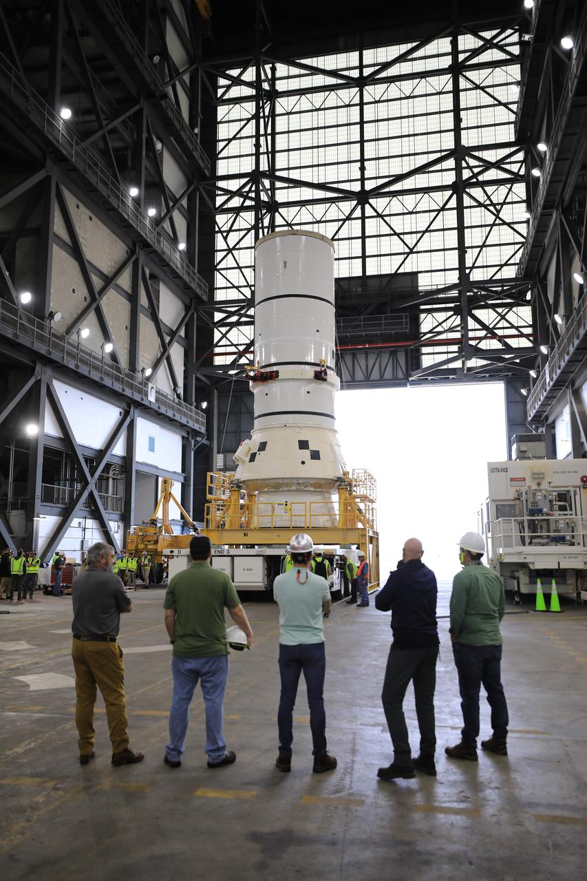 Engineers and technicians with the Exploration Ground Systems Program transport the left aft assembly, or bottom portion of the solid rocket boosters for the SLS (Space Launch System) rocket for the Artemis II mission inside the Vehicle Assembly Building at NASA’s Kennedy Space Center in Florida on Monday, Nov. 18, 2024. The aft assembly will be lifted atop the mobile launcher, followed by the right aft assembly and remaining booster segments.
