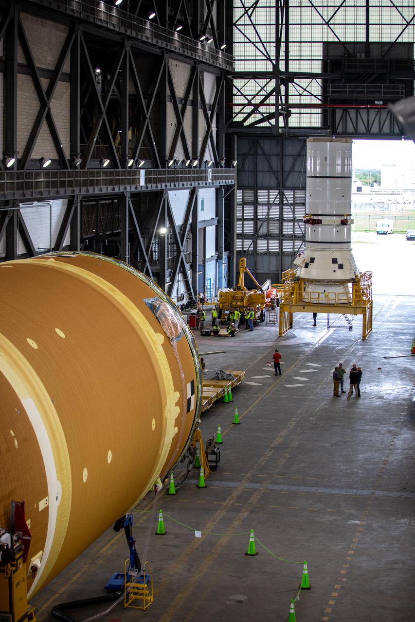 The left aft assembly, or bottom portion of the solid rocket boosters for the SLS (Space Launch System) rocket, moves into the Vehicle Assembly Building with the core stage at NASA’s Kennedy Space Center in Florida on Monday, Nov. 18, 2024. The aft assembly will be lifted atop the mobile launcher, followed by the right aft assembly and remaining rocket segments.