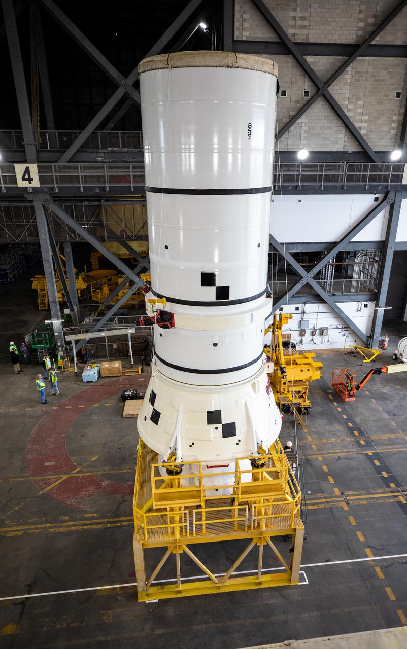 Engineers and technicians with the Exploration Ground Systems Program transport the left aft assembly, or bottom portion of the solid rocket boosters for the SLS (Space Launch System) rocket for the Artemis II mission inside the Vehicle Assembly Building at NASA’s Kennedy Space Center in Florida on Monday, Nov. 18, 2024. The aft assembly will be lifted atop the mobile launcher, followed by the right aft assembly and remaining booster segments.