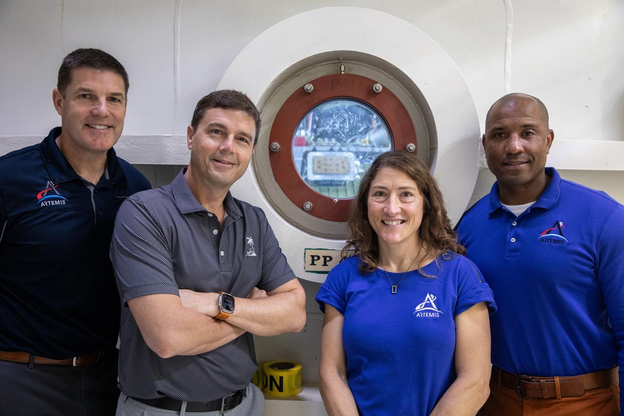 From left, the Artemis II crew, Canadian Space Agency (CSA) astronaut Jeremy Hansen, along with NASA astronauts Reid Wiseman, Christina Koch, and Victor Glover pose for a photograph in front of the altitude chamber on Tuesday, Nov. 19, 2024, inside the Neil A. Armstrong Operations and Checkout building at NASA's Kennedy Space Center in Florida. The altitude chamber simulates deep space vacuum conditions, and the testing will provide additional data to augment data gained during testing earlier this summer. The Orion spacecraft will carry the crew on a 10-day journey around the Moon and back for the Artemis II test flight.