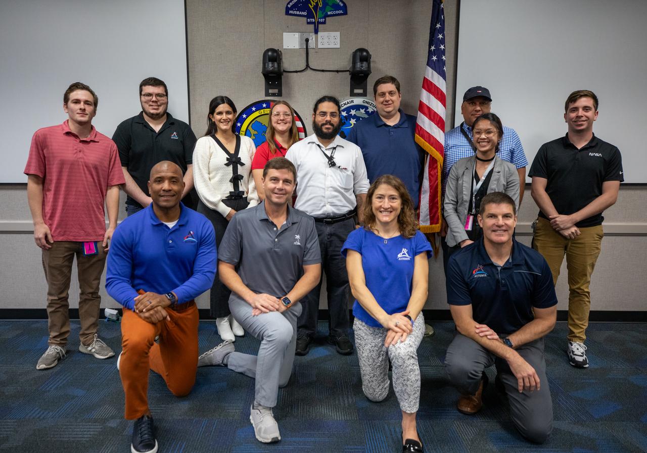 The Artemis II crew, NASA astronauts Victor Glover, left, Reid Wiseman, Christina Koch, and Canadian Space Agency (CSA) astronaut Jeremy Hansen, right, pose for a group photograph with employees from NASA’s Exploration Ground Systems Program on Tuesday, Nov. 19, 2024, inside the Neil A. Armstrong Operations and Checkout building at NASA's Kennedy Space Center in Florida.
