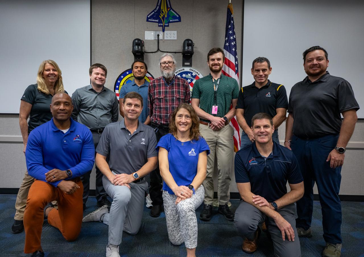 The Artemis II crew, NASA astronauts Victor Glover, left, Reid Wiseman, Christina Koch, and Canadian Space Agency (CSA) astronaut Jeremy Hansen, right, pose for a group photograph with employees from NASA’s Exploration Ground Systems Program on Tuesday, Nov. 19, 2024, inside the Neil A. Armstrong Operations and Checkout building at NASA's Kennedy Space Center in Florida.