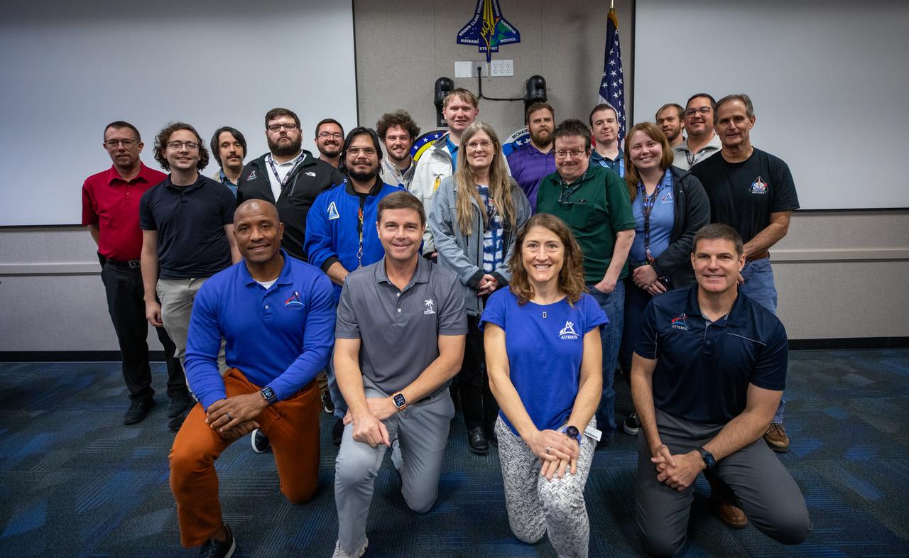 The Artemis II crew, NASA astronauts Victor Glover, left, Reid Wiseman, Christina Koch, and Canadian Space Agency (CSA) astronaut Jeremy Hansen, right, pose for a group photograph with employees from NASA’s Exploration Ground Systems Program on Tuesday, Nov. 19, 2024, inside the Neil A. Armstrong Operations and Checkout building at NASA's Kennedy Space Center in Florida.