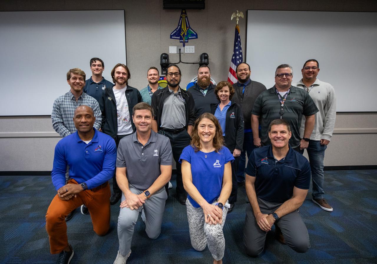 The Artemis II crew, NASA astronauts Victor Glover, left, Reid Wiseman, Christina Koch, and Canadian Space Agency (CSA) astronaut Jeremy Hansen, right, pose for a group photograph with employees from NASA’s Exploration Ground Systems Program on Tuesday, Nov. 19, 2024, inside the Neil A. Armstrong Operations and Checkout building at NASA's Kennedy Space Center in Florida.