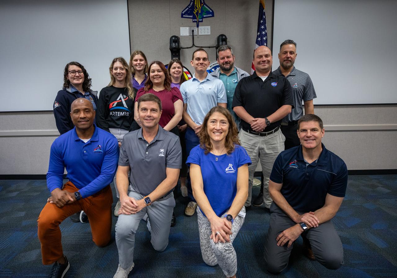 The Artemis II crew, NASA astronauts Victor Glover, left, Reid Wiseman, Christina Koch, and Canadian Space Agency (CSA) astronaut Jeremy Hansen, right, pose for a group photograph with employees from NASA’s Exploration Ground Systems Program on Tuesday, Nov. 19, 2024, inside the Neil A. Armstrong Operations and Checkout building at NASA's Kennedy Space Center in Florida.