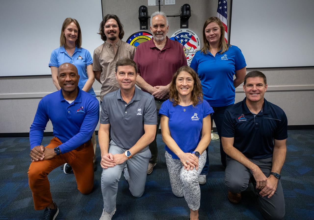 The Artemis II crew, NASA astronauts Victor Glover, left, Reid Wiseman, Christina Koch, and Canadian Space Agency (CSA) astronaut Jeremy Hansen, right, pose for a group photograph with employees from NASA’s Exploration Ground Systems Program on Tuesday, Nov. 19, 2024, inside the Neil A. Armstrong Operations and Checkout building at NASA's Kennedy Space Center in Florida.