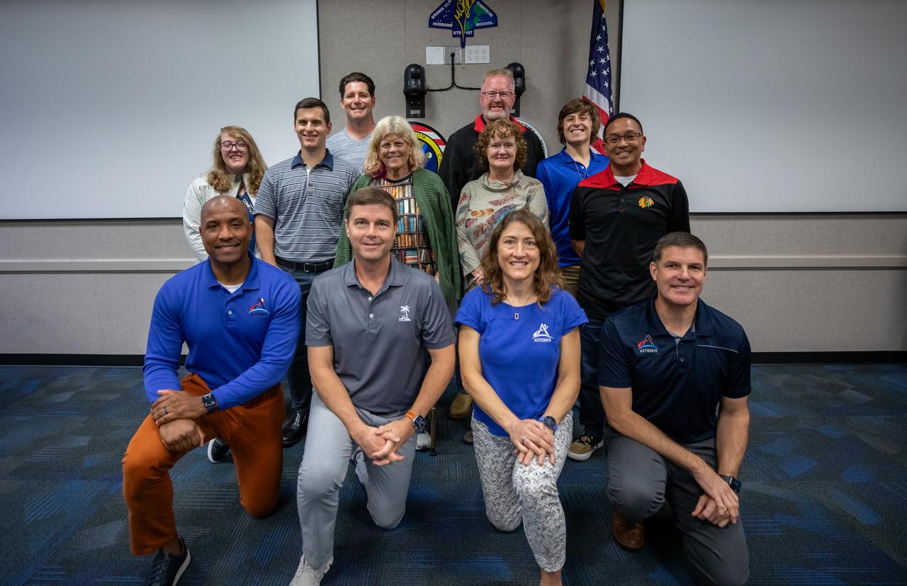 The Artemis II crew, NASA astronauts Victor Glover, left, Reid Wiseman, Christina Koch, and Canadian Space Agency (CSA) astronaut Jeremy Hansen, right, pose for a group photograph with employees from NASA’s Exploration Ground Systems Program on Tuesday, Nov. 19, 2024, inside the Neil A. Armstrong Operations and Checkout building at NASA's Kennedy Space Center in Florida.