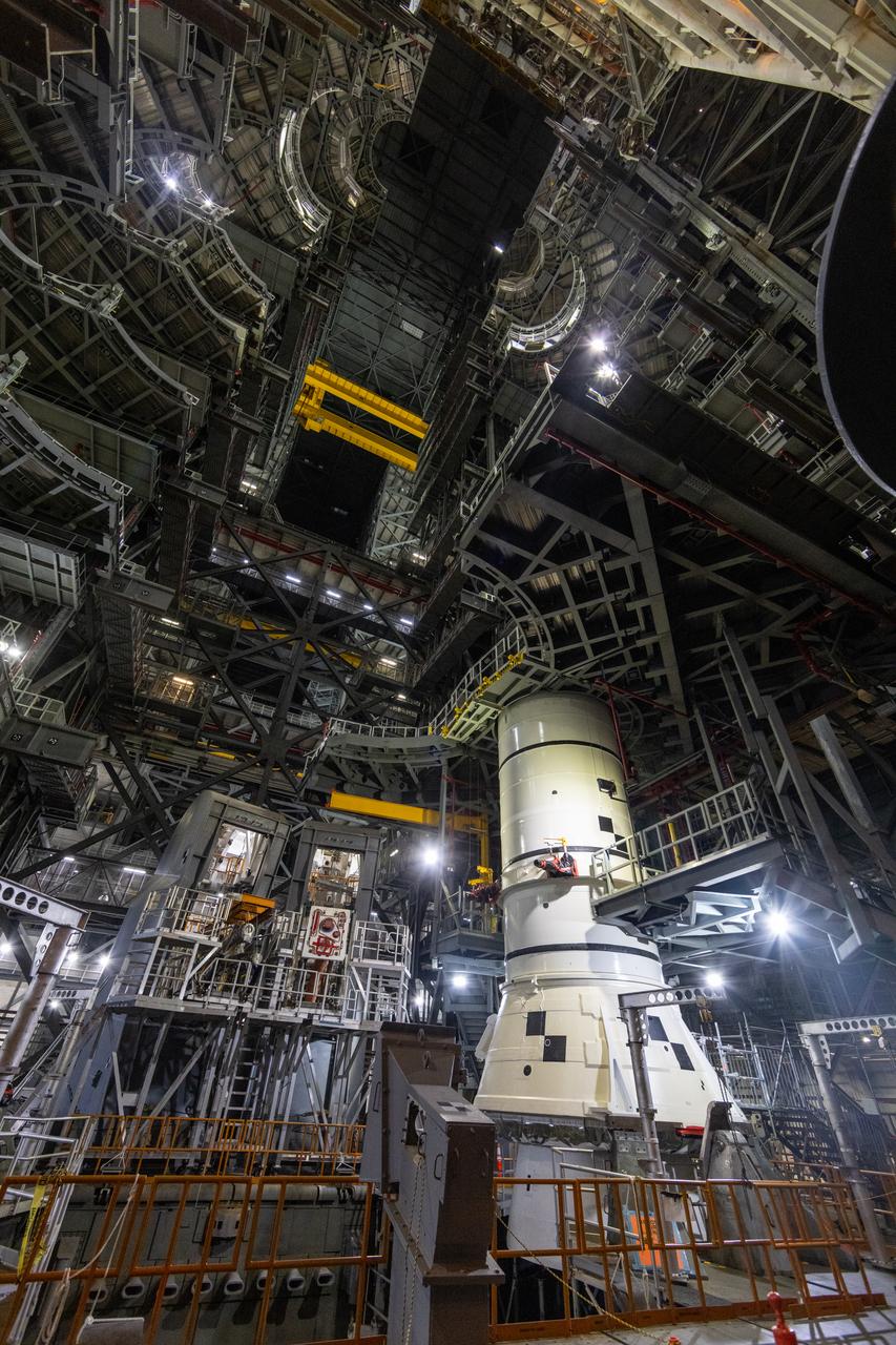Engineers and technicians with the Exploration Ground Systems Program stack the first Moon rocket segment – the left aft assembly for the Artemis II SLS (Space Launch System) solid rocket booster onto mobile launcher 1 inside the Vehicle Assembly Building at NASA’s Kennedy Space Center on Wednesday, Nov. 20, 2024. The first of 10 booster segments to be stacked, the boosters will help support the remaining rocket components and the Orion spacecraft during final assembly of the Artemis II Moon rocket and provide more than 75 percent of the total SLS thrust during liftoff from NASA Kennedy’s Launch Pad 39B.