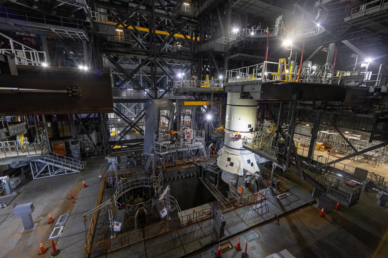 Engineers and technicians with the Exploration Ground Systems Program stack the first Moon rocket segment – the left aft assembly for the Artemis II SLS (Space Launch System) solid rocket booster onto mobile launcher 1 inside the Vehicle Assembly Building at NASA’s Kennedy Space Center on Wednesday, Nov. 20, 2024. The first of 10 booster segments to be stacked, the boosters will help support the remaining rocket components and the Orion spacecraft during final assembly of the Artemis II Moon rocket and provide more than 75 percent of the total SLS thrust during liftoff from NASA Kennedy’s Launch Pad 39B.