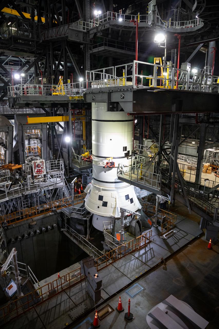 Engineers and technicians with the Exploration Ground Systems Program stack the first Moon rocket segment – the left aft assembly for the Artemis II SLS (Space Launch System) solid rocket booster onto mobile launcher 1 inside the Vehicle Assembly Building at NASA’s Kennedy Space Center on Wednesday, Nov. 20, 2024. The first of 10 booster segments to be stacked, the boosters will help support the remaining rocket components and the Orion spacecraft during final assembly of the Artemis II Moon rocket and provide more than 75 percent of the total SLS thrust during liftoff from NASA Kennedy’s Launch Pad 39B.