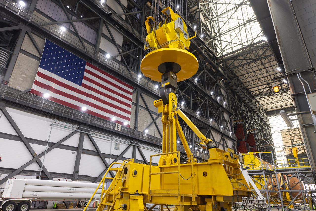 Engineers and technicians with NASA’s Exploration Ground Systems Program move the right aft assembly, or bottom portion of the right solid rocket booster for the agency’s SLS (Space Launch System) rocket, into inside the Vehicle Assembly Building at NASA’s Kennedy Space Center on Thursday, Nov. 22, 2024. The crane will lift the right aft assembly on top of mobile launcher 1, joining the previously stacked left aft assembly as the first booster segments stacked for the Artemis II Moon rocket.