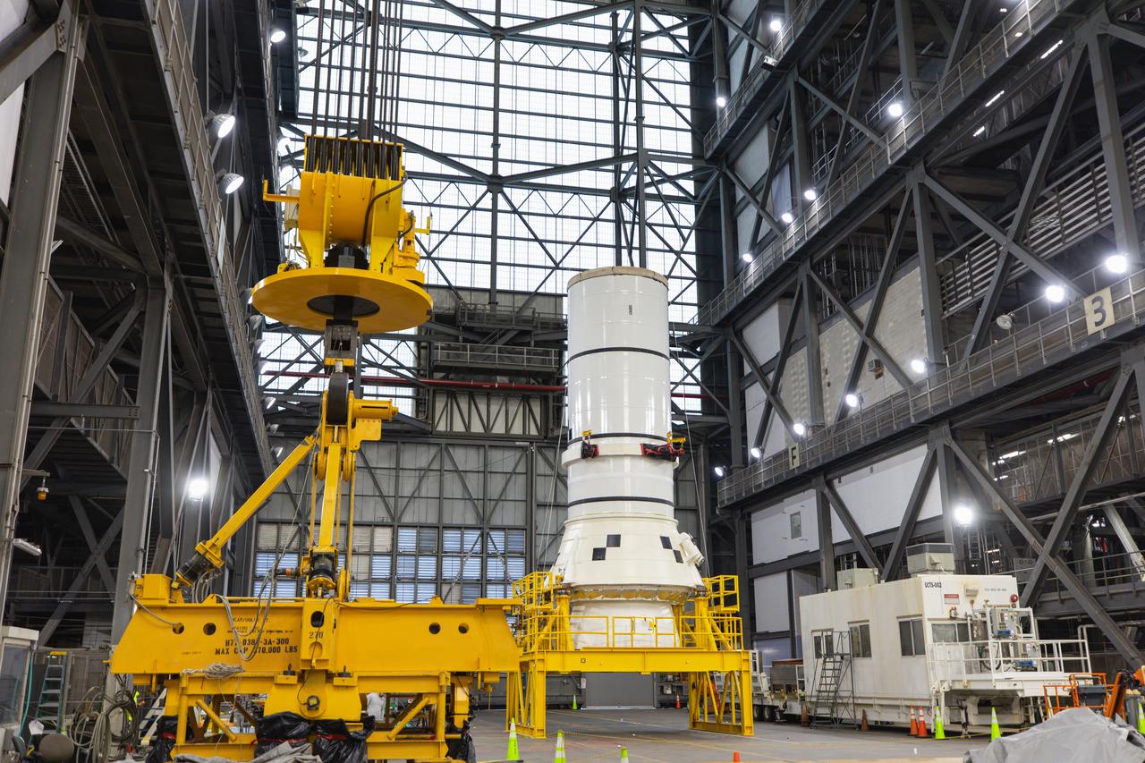 Engineers and technicians with NASA’s Exploration Ground Systems Program move the right aft assembly, or bottom portion of the right solid rocket booster for the agency’s SLS (Space Launch System) rocket, into inside the Vehicle Assembly Building at NASA’s Kennedy Space Center on Thursday, Nov. 22, 2024. The crane will lift the right aft assembly on top of mobile launcher 1, joining the previously stacked left aft assembly as the first booster segments stacked for the Artemis II Moon rocket.
