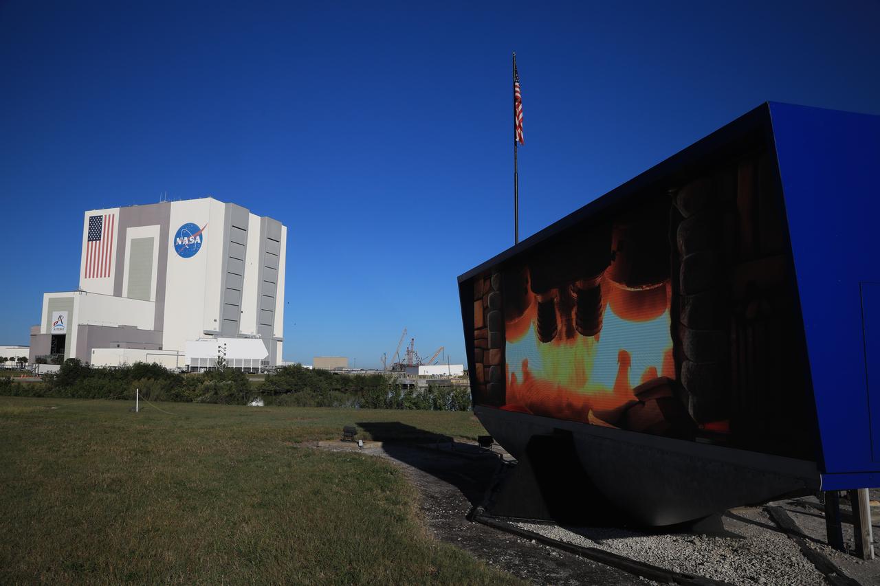 NASA’s SLS (Space Launch System) rocket that launched Artemis I on a mission around the Moon and back becomes a “rocket engine fireplace” back drop video on the historic countdown clock at the NASA News Center at the agency’s Kennedy Space Center on Tuesday, Nov. 26, 2024. The fireplace showcases the SLS rocket’s four RS-25 engines and a pair of solid rocket boosters. 